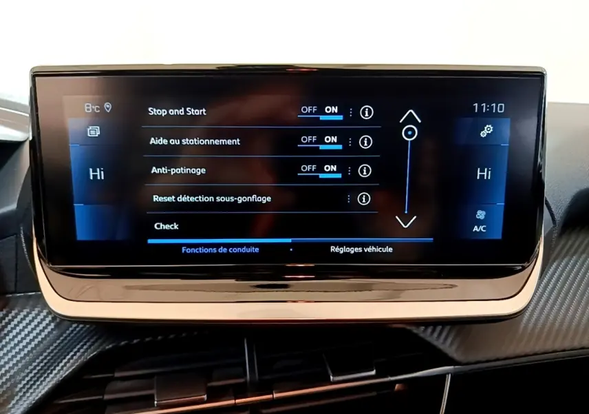 Écran tactile central de la Peugeot 208 jaune, affichant les réglages d’aide à la conduite et climatisation.