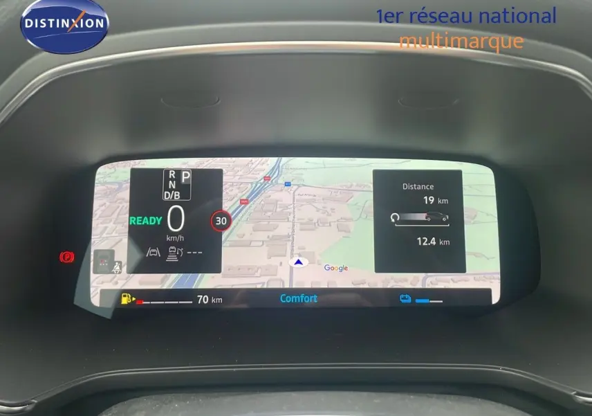 Tableau de bord numérique du Renault Captur E-Tech blanc nacré, affichant navigation et informations de conduite.