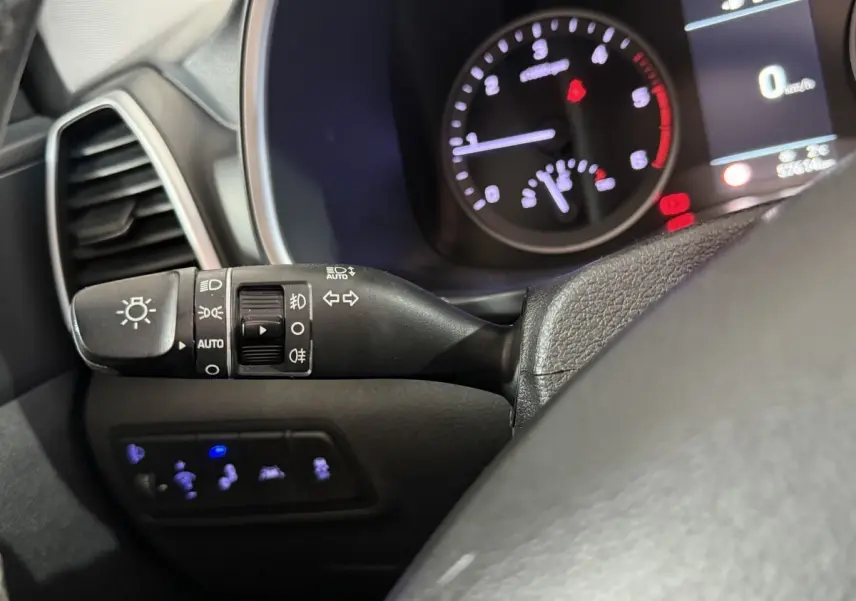 Gros plan sur la commande des phares et clignotants côté gauche du tableau de bord du Hyundai Tucson noir 2019.