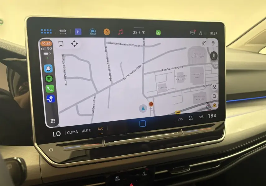Écran tactile central affichant la navigation dans l’habitacle clair d’une Volkswagen Golf Blanc Oryx nacré.