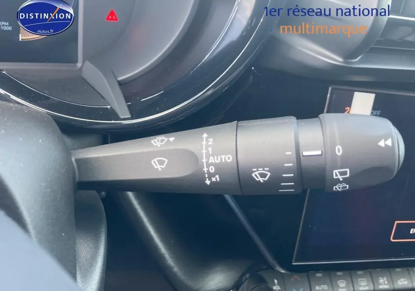Gros plan sur la commande d’essuie-glace à gauche du volant dans l’habitacle d’une Alfa Romeo Junior gris 2026.