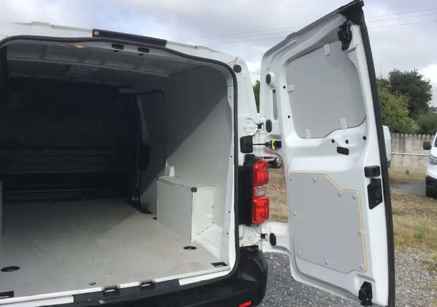 Vue arrière ouverte du FIAT Scudo Fourgon blanc 2024, montrant l’espace de chargement vide et la porte droite ouverte.