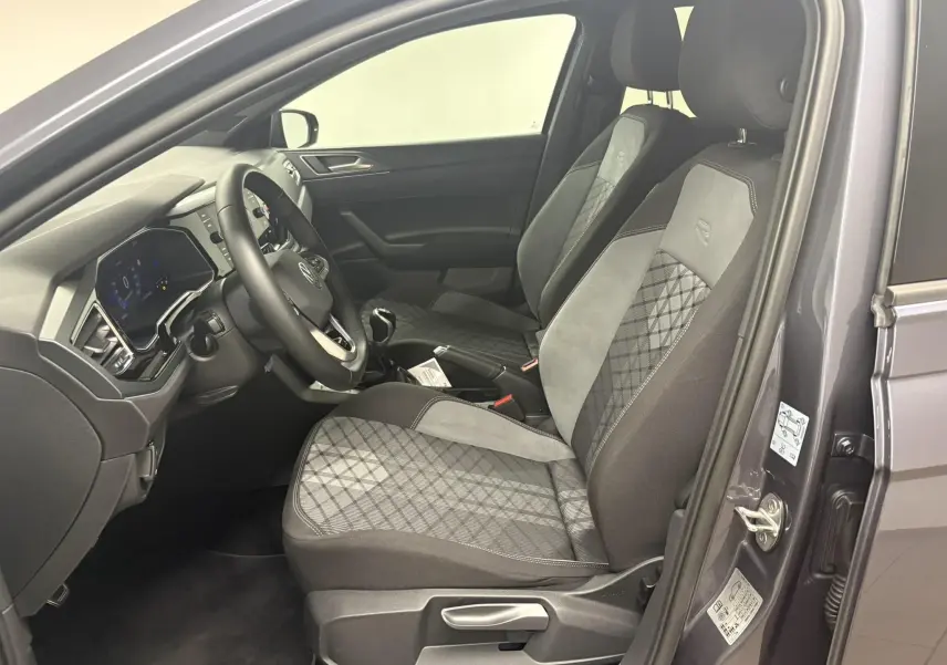 Intérieur côté conducteur de la Volkswagen Polo 1.0 TSI R-Line 2025 en gris cendré, sièges tissu avec motif et volant multifonction.