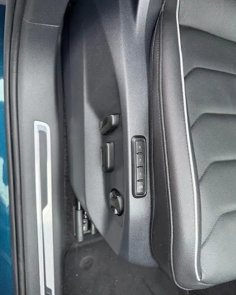 Vue rapprochée des commandes électriques du siège conducteur en cuir noir du Volkswagen Tiguan Night Shade Blue 2022.