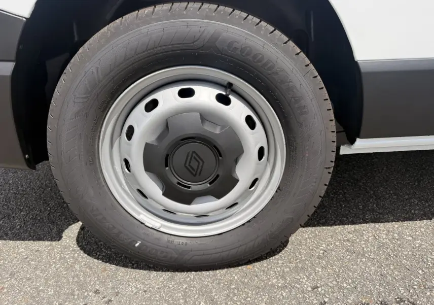 Gros plan sur la roue avant droite du Renault Trafic Fourgon blanc avec jante acier et logo Renault central.