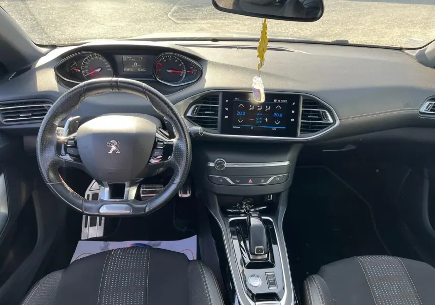 Intérieur Peugeot 308 SW gris clair, vue frontale du poste de conduite avec volant compact et écran tactile central.