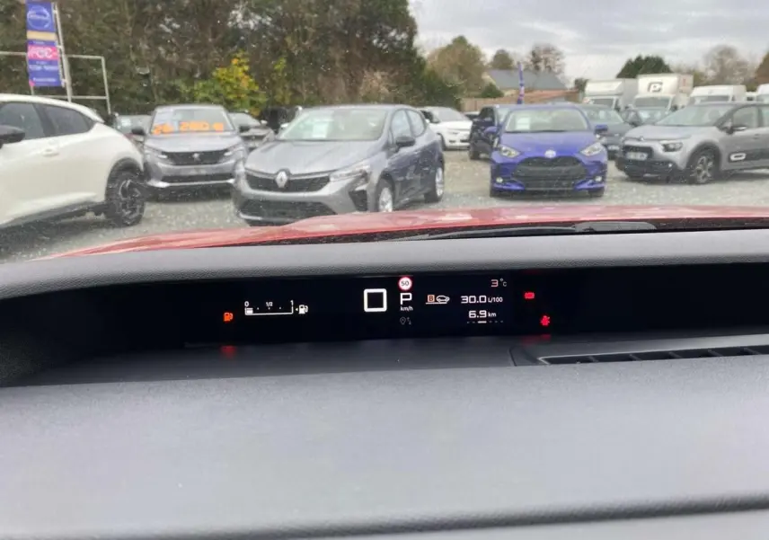 Vue intérieure du tableau de bord numérique d'une Citroën C3 Aircross rouge Elixir avec affichage multifonction.