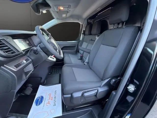 Vue intérieure côté conducteur du Citroën Jumpy noir 2026, montrant la banquette avant trois places et le tableau de bord moderne.