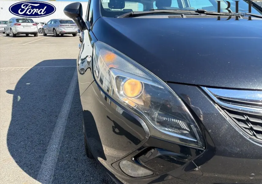 Gros plan sur l'avant gauche gris métal de l'Opel Zafira Tourer avec phare allumé et calandre chromée visible.