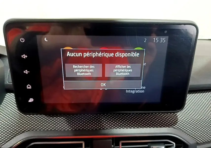 Écran tactile central du tableau de bord de la Dacia Sandero blanc, affichant un message Bluetooth.