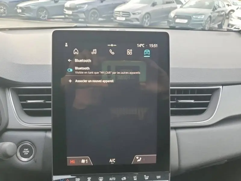 Vue intérieure centrée sur l'écran tactile du tableau de bord du Renault Captur gris Cassiopée, affichant les réglages Bluetooth.