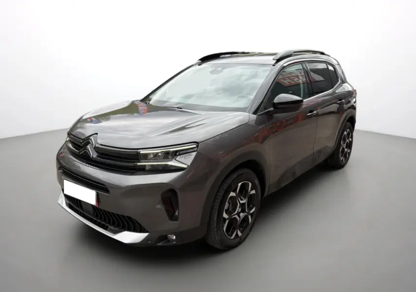 Citroën C5 Aircross Hybrid gris platinium en 3/4 avant droit avec barres de toit et jantes alu 18 pouces.