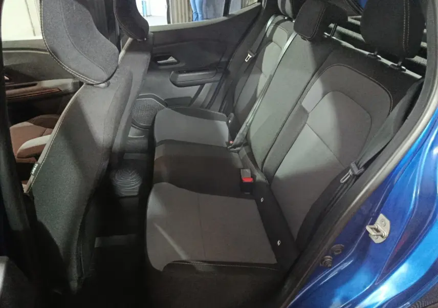Vue intérieure côté droit sur la banquette arrière grise et noire d'une Dacia Sandero Extreme+ TCe 110 bleu 2024.