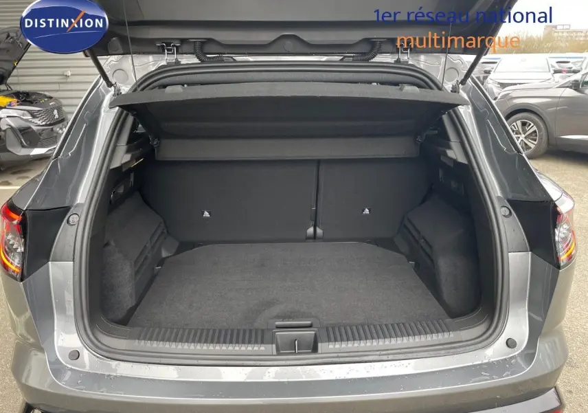 Coffre ouvert vu de l'arrière d'un Renault Austral gris schiste métallisé, montrant l'espace de chargement vide.