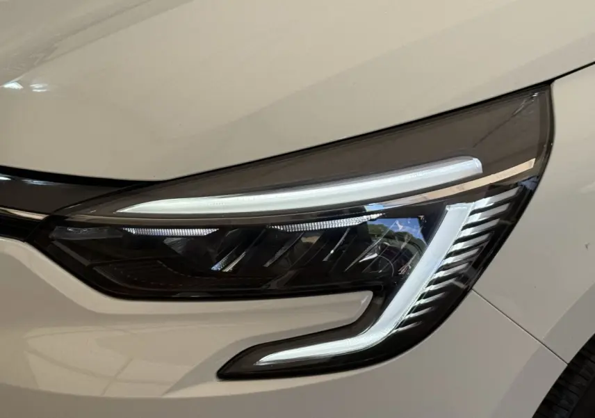 Gros plan sur le phare avant droit blanc de la Renault Clio Evolution TCe 100 GPL 2023 avec LED distinctive.
