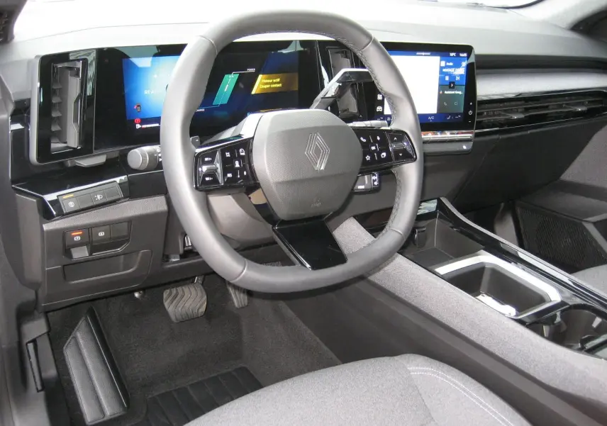 Vue intérieure du tableau de bord et volant du Renault Austral 2025, avec écran digital et finitions modernes grises.