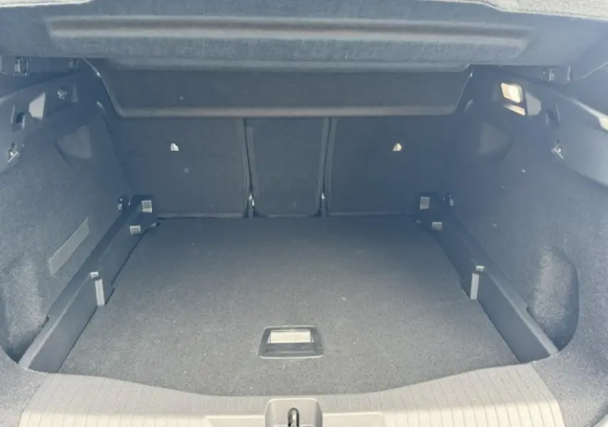 Coffre ouvert en vue arrière d'un Citroën C5 Aircross gris Platinium, espace de chargement spacieux et tapis noir.