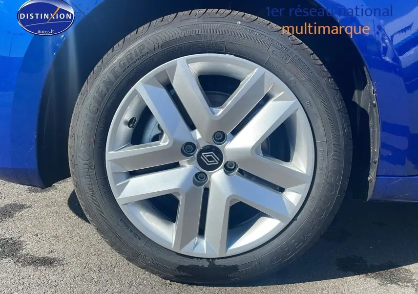 Gros plan sur la roue avant gauche avec enjoliveur argenté d'une Renault Clio V bleu iron 2025.