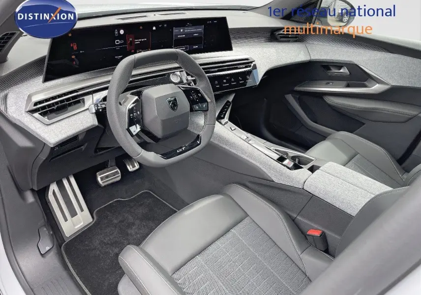 Intérieur avant du Peugeot 5008 Hybrid 2025, avec tableau de bord numérique et sièges cuir noir et tissu gris.