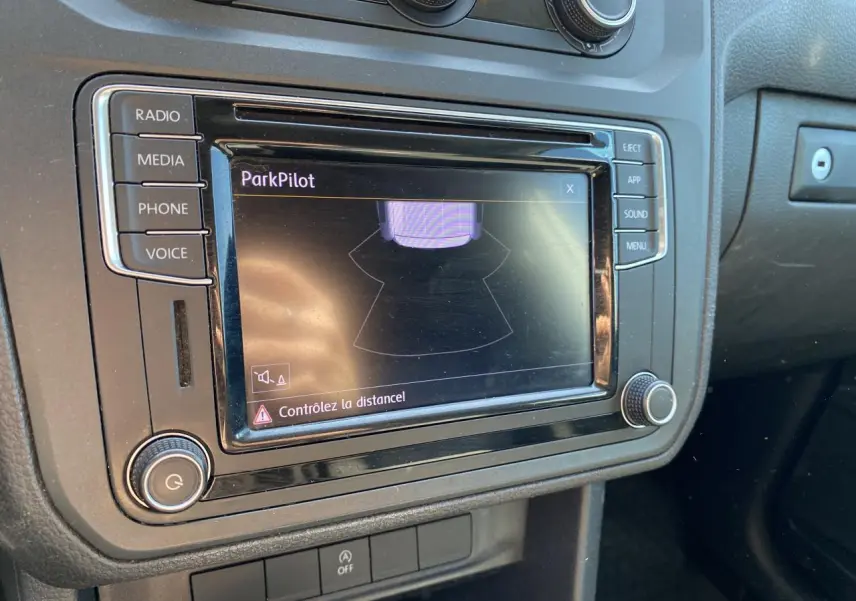 Gros plan sur l'écran central du Volkswagen Caddy 2020 montrant l'alerte ParkPilot avec commandes autour.