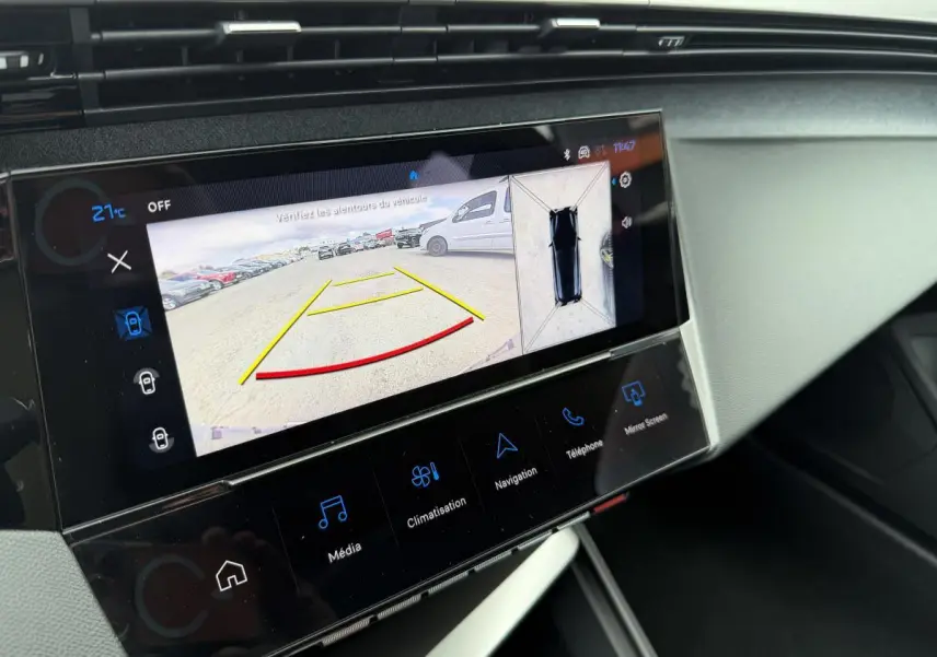 Écran tactile central de la Peugeot 308 SW rouge montrant la caméra de recul et l'affichage 360° intérieur.