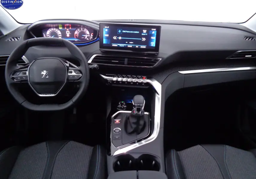 Vue intérieure du tableau de bord du Peugeot 3008 2023, avec volant compact, écran tactile central et console moderne.