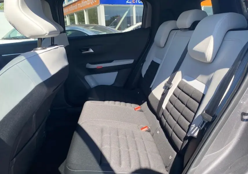 Vue intérieure arrière droite du Citroën C3 Aircross 2026, sièges bicolores gris clair et noir avec appuis-tête intégrés.
