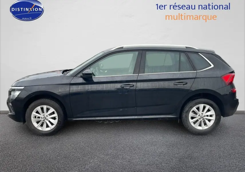 Profil côté gauche du SUV noir Škoda Kamiq 2025 avec jantes alliage et barres de toit visibles.