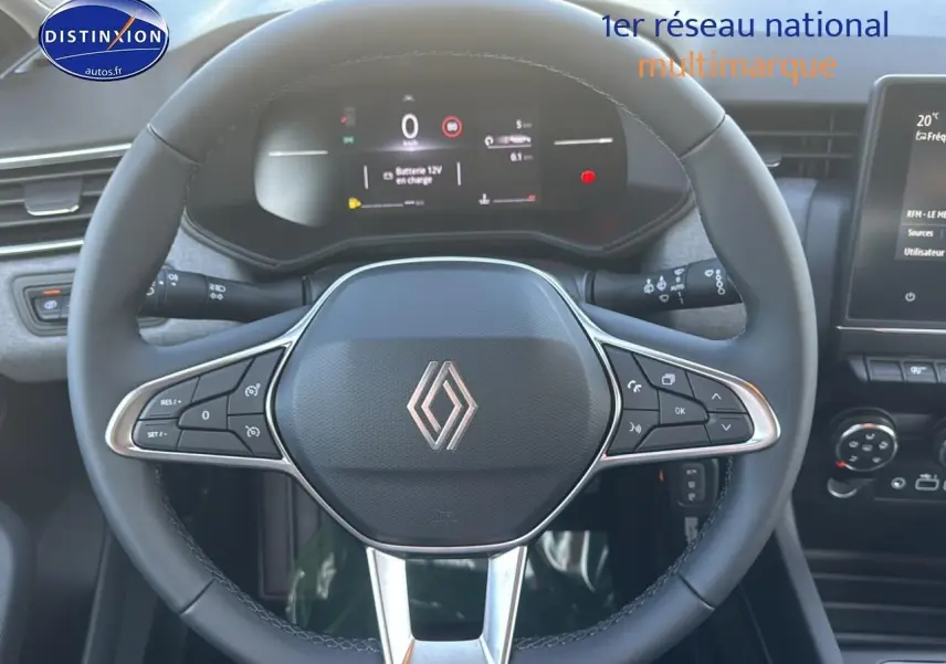 Vue rapprochée du volant multifonction noir de la Renault Clio V 1.5 Blue dCi 100 Evolution avec tableau de bord numérique.