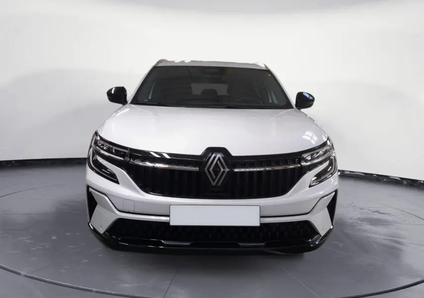 Vue frontale du Renault Espace blanc nacré 2025 avec calandre noire et feux LED adaptatifs.