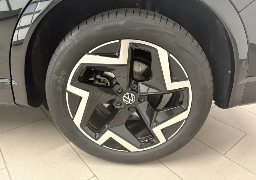 Gros plan sur la roue avant droite du Volkswagen Tiguan 2025 noir intense nacré avec jante alliage R-Line distinctive.