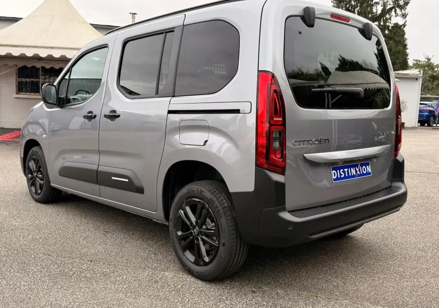 Vue 3/4 arrière droit du Citroën Berlingo gris Artense avec vitres teintées et jantes noires.