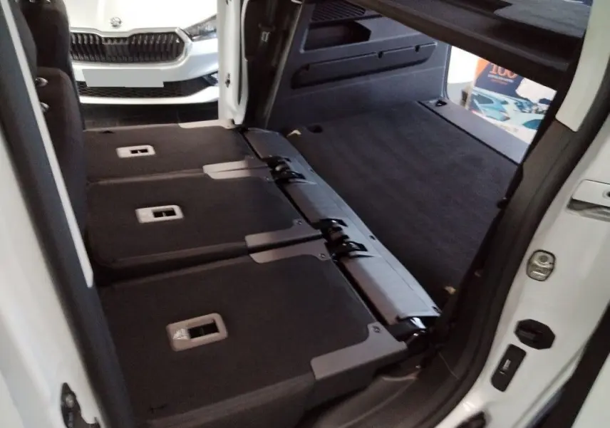 Vue 3/4 arrière droite du Citroën Berlingo gris Artense avec feux arrière rouges et jantes noires.