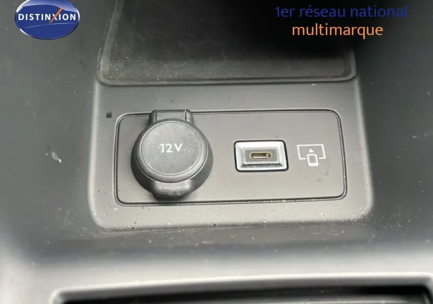 Gros plan sur la prise 12V et port USB-C dans l’intérieur noir du Peugeot 408 Hybrid 145ch GT 2024.