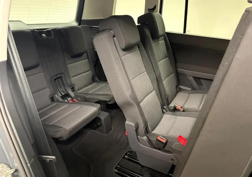 Vue intérieure côté droit sur les sièges arrière 7 places en tissu gris du Volkswagen Touran 2025.
