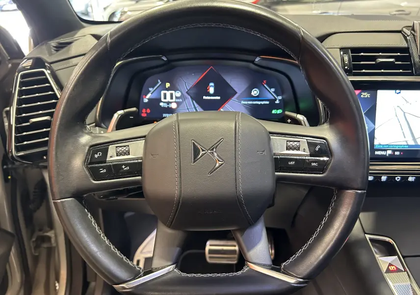Vue rapprochée du volant en cuir noir du DS7 Crossback 2022 avec tableau de bord numérique et écran tactile.