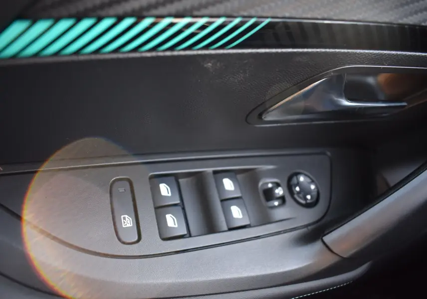 Commande des vitres électriques et réglage des rétroviseurs sur la porte côté gauche d'un Peugeot 2008 bleu 2021 finition Allure.