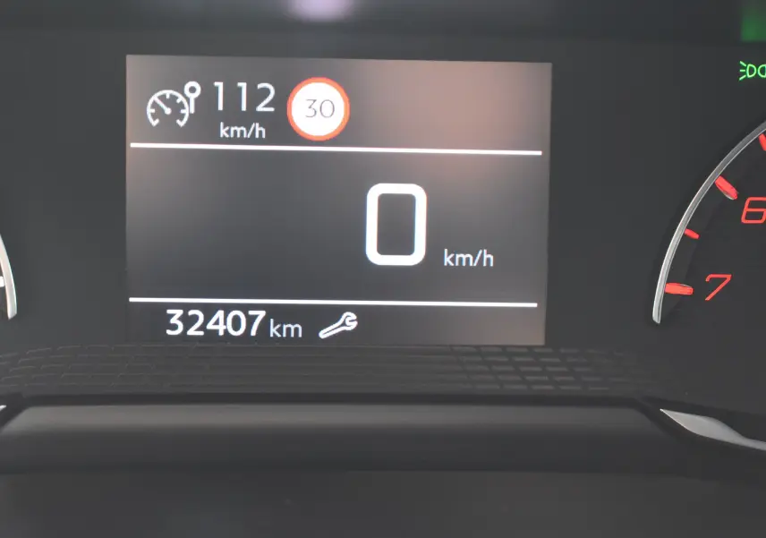 Tableau de bord du Peugeot 2008 bleu 2021 montrant 32 407 km et vitesse à 0 km/h au compteur numérique.