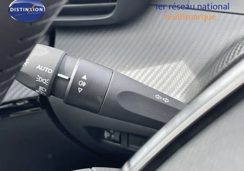Gros plan sur la commande des phares et clignotants dans l'habitacle d'une Peugeot 208 2025.
