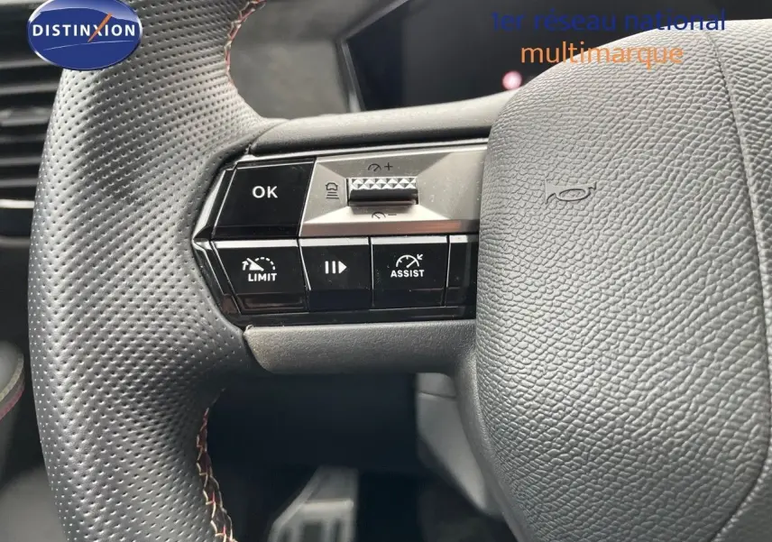 Gros plan sur le volant en cuir noir perforé du DS4 2024 avec commandes intégrées côté gauche.