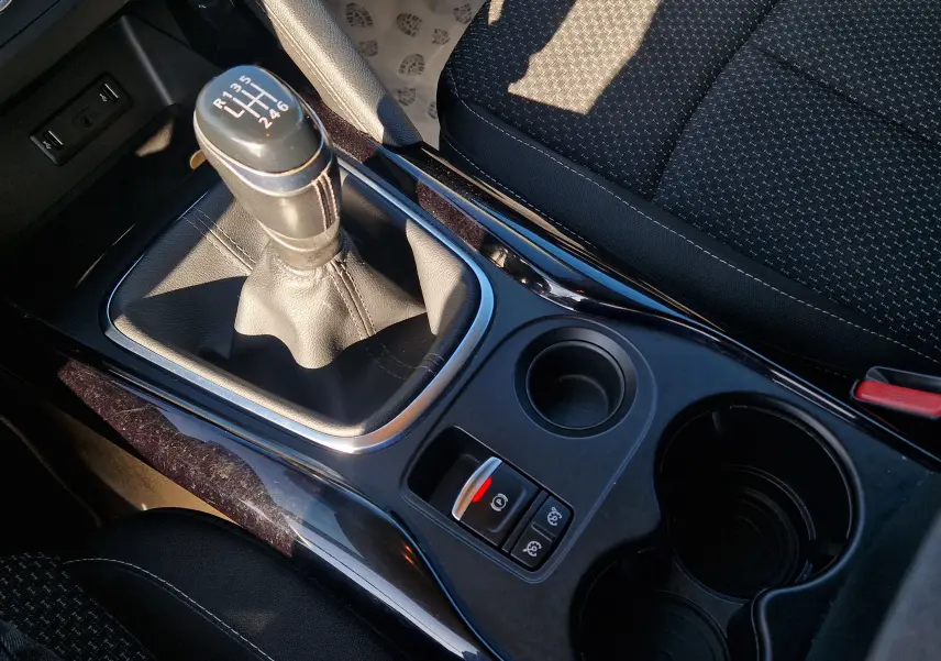 Gros plan sur la console centrale du Renault Kadjar bleu cosmos 2020, avec levier de vitesses manuel et porte-gobelets.
