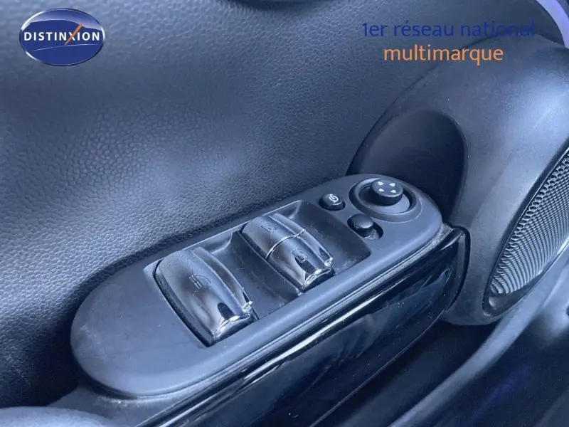 Gros plan sur les commandes de lève-vitres et rétroviseurs côté conducteur d'une MINI Cabriolet noire.