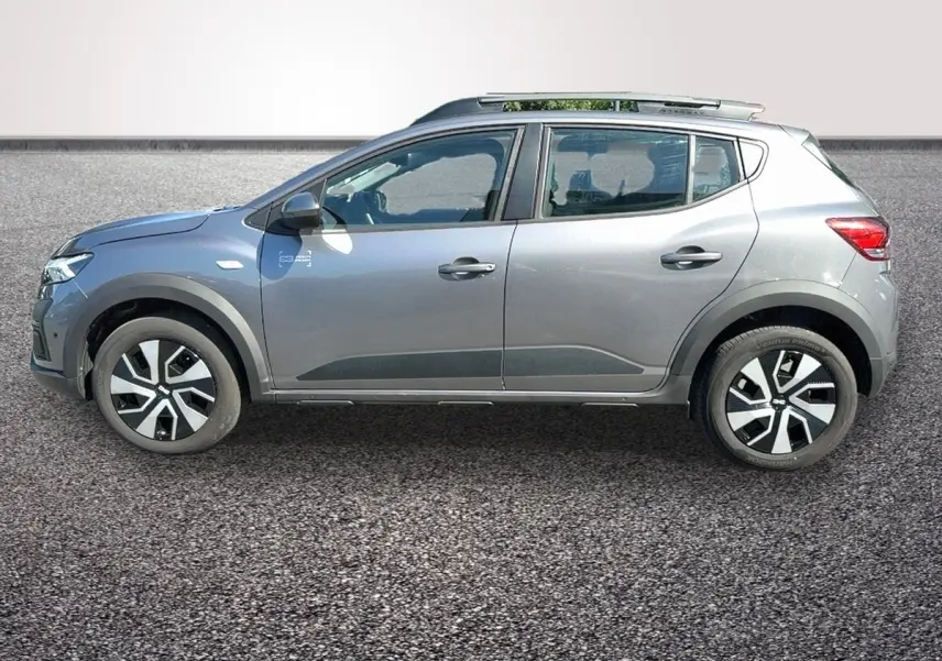 Profil côté gauche d'une Dacia Sandero Stepway gris foncé avec barres de toit et jantes distinctives.