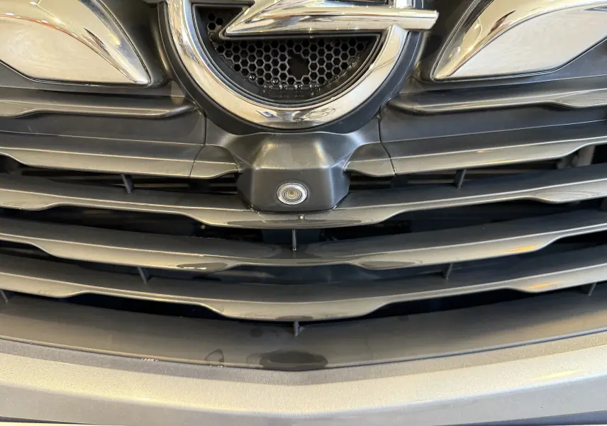 Gros plan sur la calandre gris métallisé de l’Opel Grandland X 1.6 Hybrid Turbo 2021 avec caméra frontale intégrée.