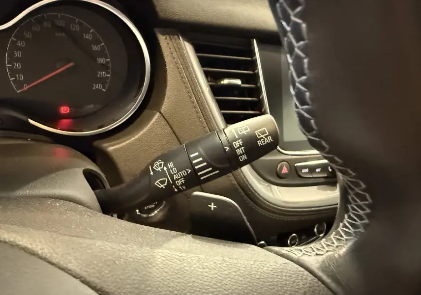 Gros plan sur la manette d'essuie-glace côté gauche du tableau de bord d'un Opel Grandland X gris Himalaya.