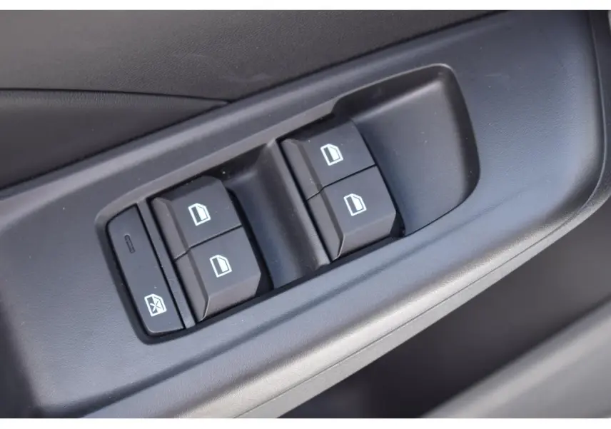 Gros plan sur les commandes des vitres électriques côté gauche de la porte d'une MG3 blanche 2026.