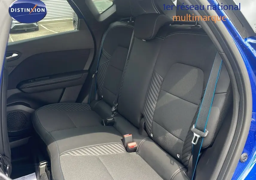 Vue intérieure sur les sièges arrière noirs avec surpiqûres bleues du Renault Captur E-Tech Hybrid 2025 côté droit ouvert.