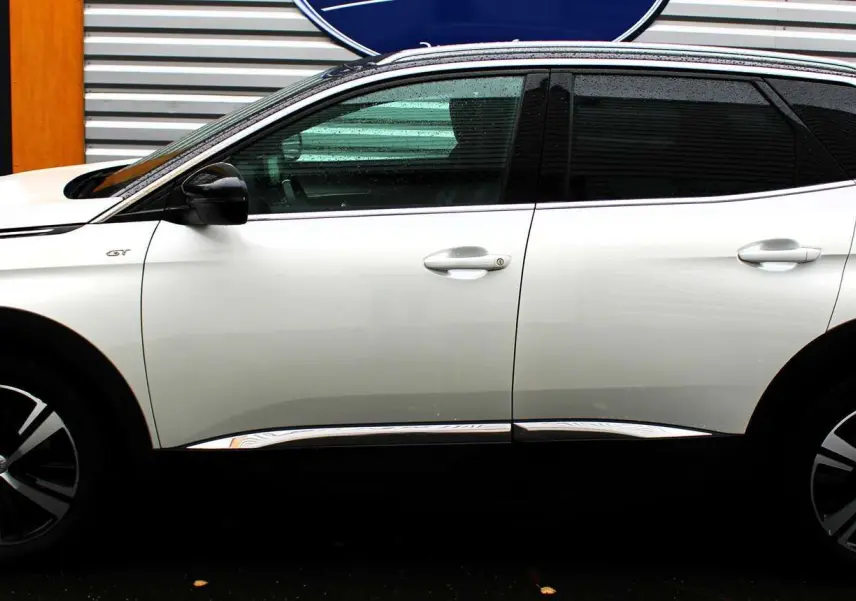 Profil côté gauche d'un Peugeot 3008 blanc nacré 2025 GT avec toit panoramique ouvrant et jantes bi-ton.