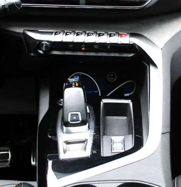 Vue rapprochée de la console centrale du Peugeot 3008 blanc nacré 2025, avec levier de vitesse automatique et écran tactile.
