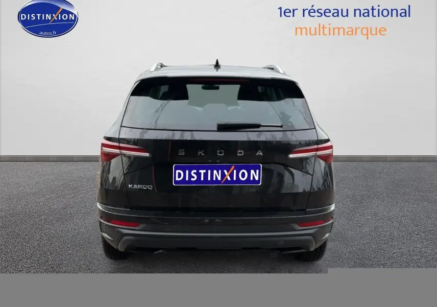 Vue arrière d'un Skoda Karoq noir 2025 avec feux arrière LED et barres de toit visibles.